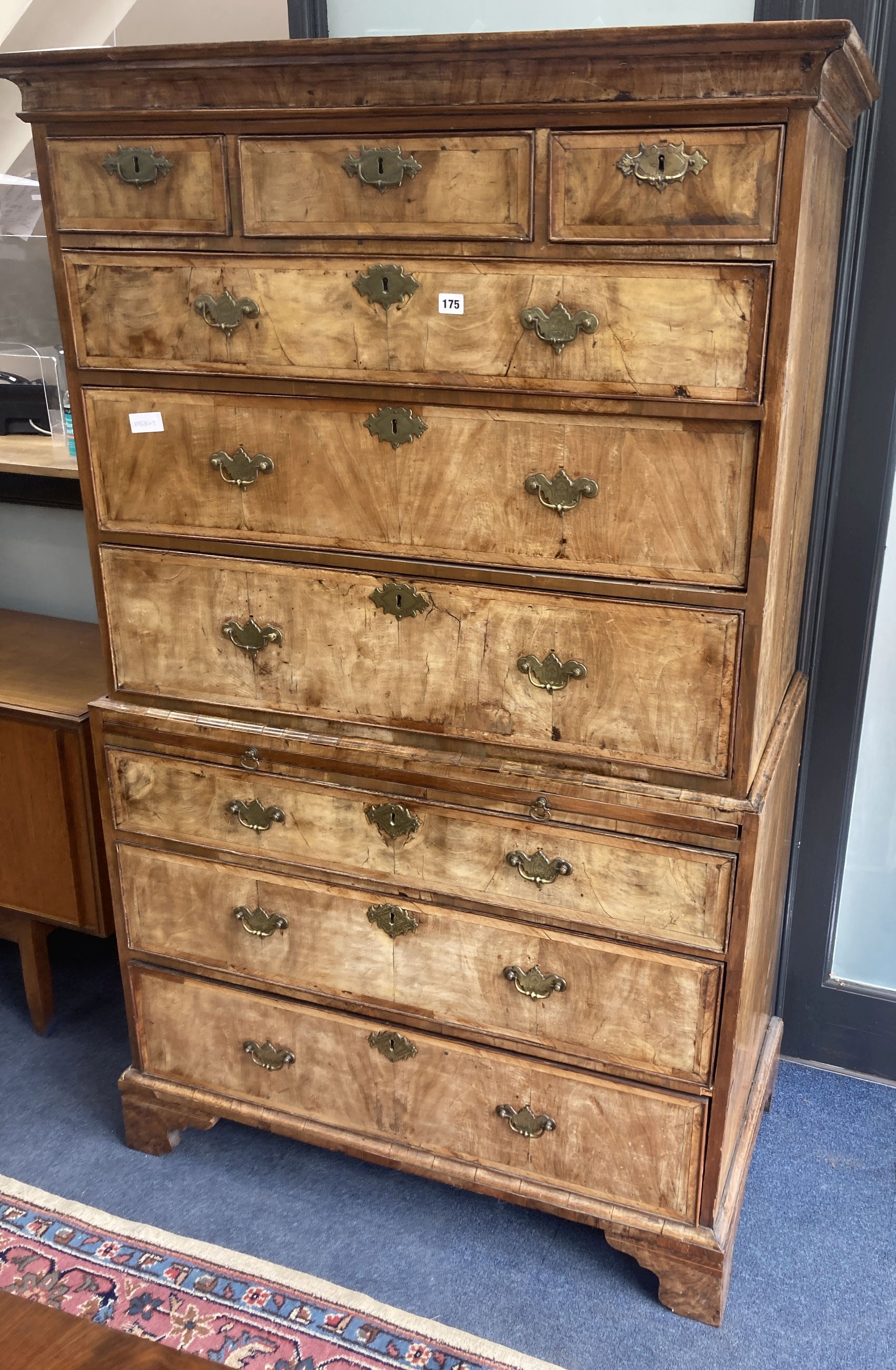 An early 18th century banded walnut tallboy, with oak sides, fitted three small and six long drawers with a brushing slide, width 105cm